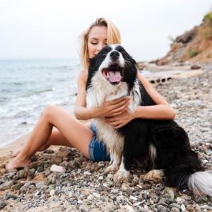 female and dog at beach